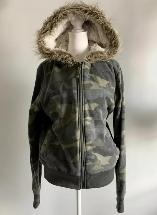 Camouflage hoodie with fur-lined hood on a mannequin against a neutral background
